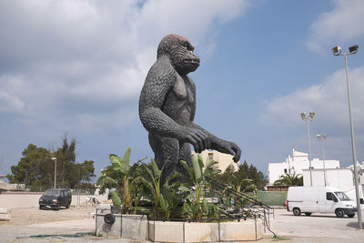 Statue by trees against sky