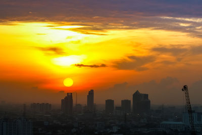 Scenic view of buildings against romantic sky at sunset