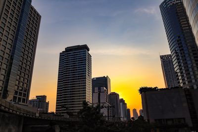 Low angle view of buildings against sky during sunset