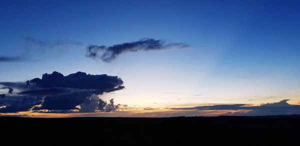 Scenic view of silhouette landscape against sky at sunset