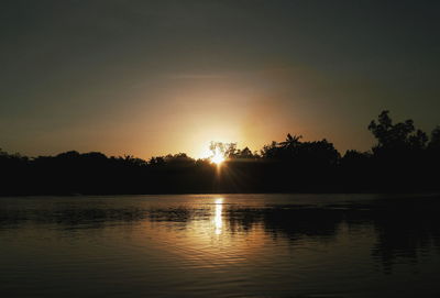 Scenic view of lake at sunset