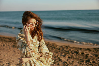 Young woman standing at beach