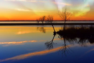 Scenic view of lake against romantic sky at sunset