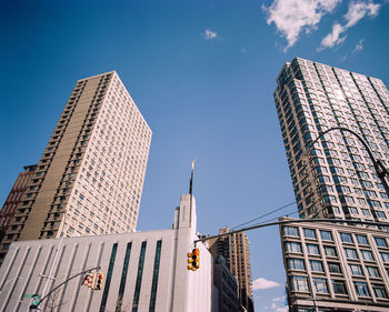 Low angle view of modern buildings against blue sky