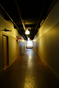 Empty corridor in illuminated tunnel