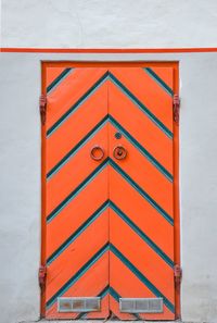 Closed orange patterned door of building