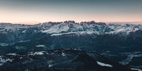 Scenic view of snowcapped mountains against sky during sunset