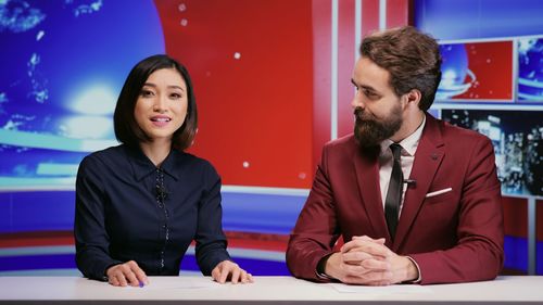 Portrait of smiling couple standing in office