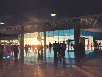 Group of people walking in illuminated building