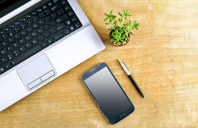 Directly above shot of smart phone and laptop on table