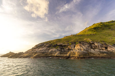 Scenic cape view of sea against sky