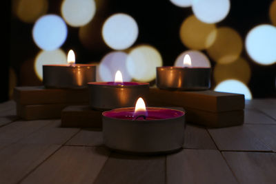 Close-up of tea light candles on table