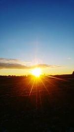 Scenic view of field against sky during sunset