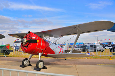 Airplane on airport runway against sky