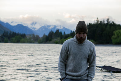 Portrait of man standing in sea against sky