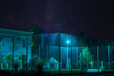 Illuminated built structure against sky at night