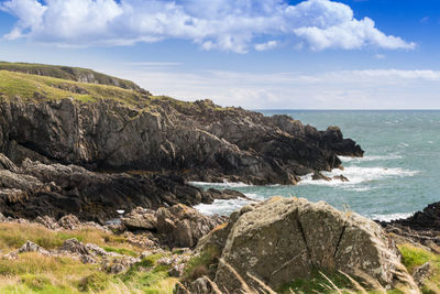 Scenic view of sea and rocks against sky