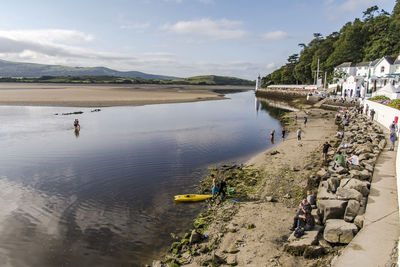 People on beach against sky