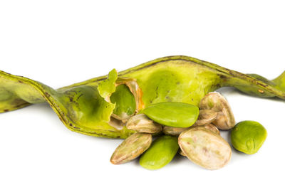 Close-up of green chili pepper against white background