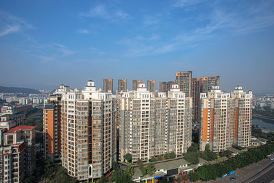 High angle view of modern buildings in city against sky