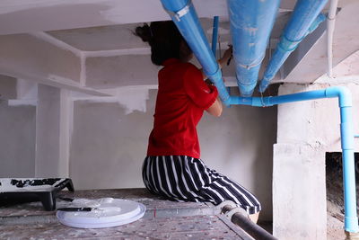 Woman painting ceiling