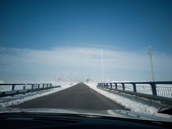 Bridge over sea against sky