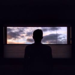 Silhouette of man against cloudy sky