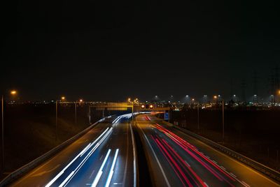 High angle view of light trails on road at night