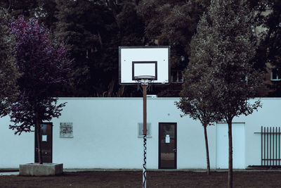 Low angle view of basketball hoop against trees