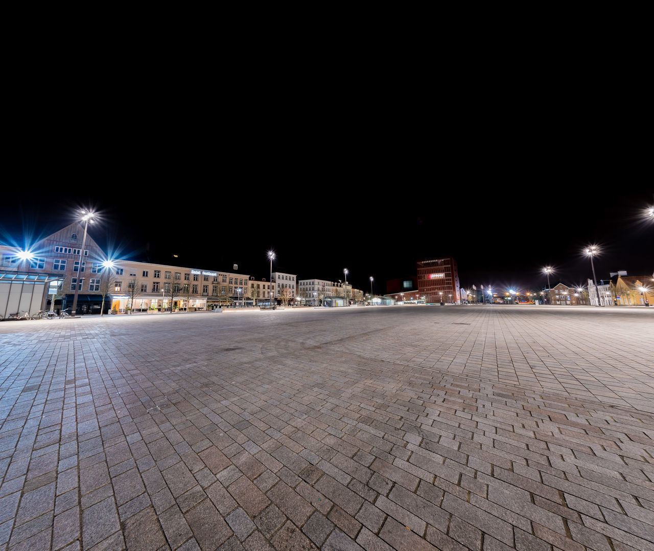 SURFACE LEVEL OF EMPTY ROAD AGAINST SKY AT NIGHT