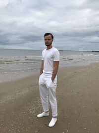 Full length portrait of man standing on beach