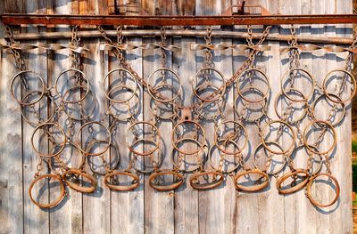 Rusty metal hanging against wooden wall