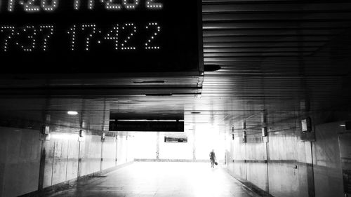 People walking in illuminated tunnel