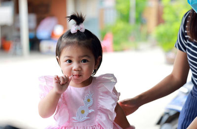Young thai girl with sugar and a sweet expression. a young girl eats candy.