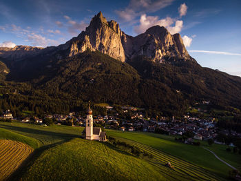 Aerial view of townscape and mountains against sky