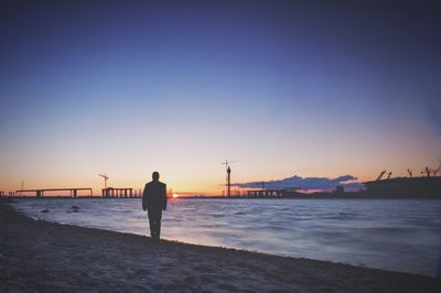 Woman in sea at sunset