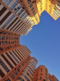 Low angle view of modern buildings against clear sky