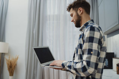 Young man using laptop at home