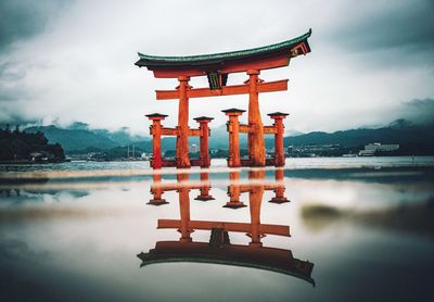 Gazebo in lake against sky