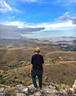 Low angle view of man standing on cliff