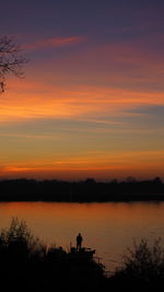  fishing on lake, orange sky