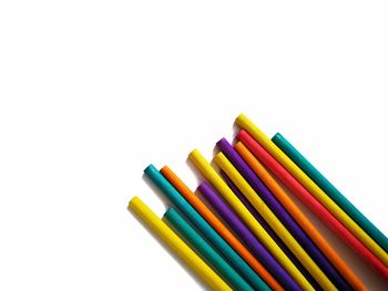 Close-up of colored pencils against white background