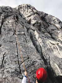 Rear view of man climbing on rocky mountain