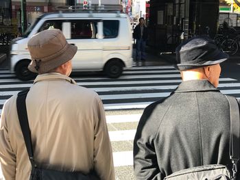 Rear view of man standing in city