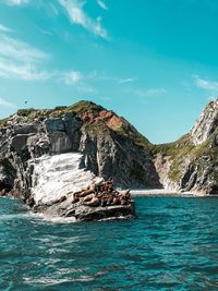 Scenic view of sea and rock formation against sky