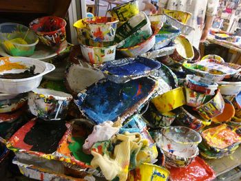 Close-up of paint containers on table