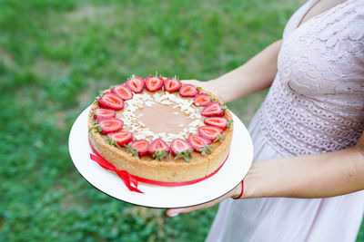 Midsection of woman holding ice cream