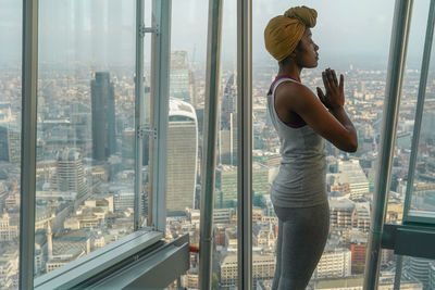 Woman looking through window