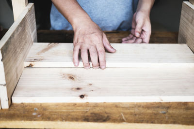 Low section of man on wooden floor