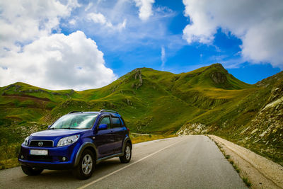 Road amidst mountains against sky